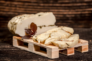 Soy cheese. classic tofu cheese on a wooden board on the kitchen table. eco cheese
