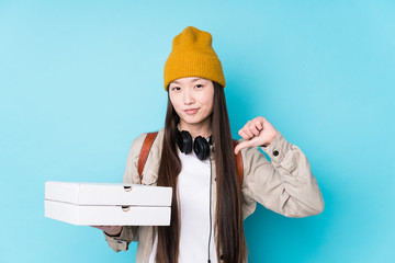 Young chinese woman holding pizzas isolated feels proud and self confident, example to follow.