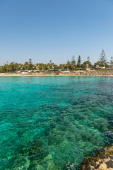 CYPRUS, NISSI BEACH - MAY 12/2018: Tourists relax and swim on one of the most popular beaches on the island.
