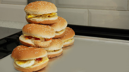 mountain of ready-made cheeseburgers and burgers