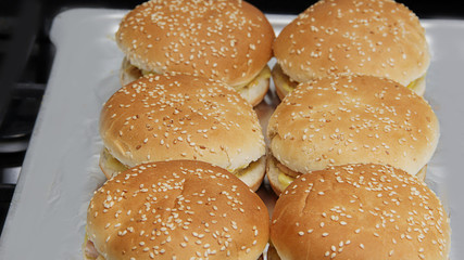 fresh freshly prepared hamburgers and cheeseburgers on a tray