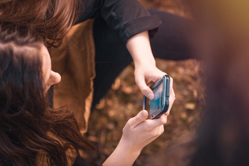 Girl looking at mobile phone texting, using rugged phone case