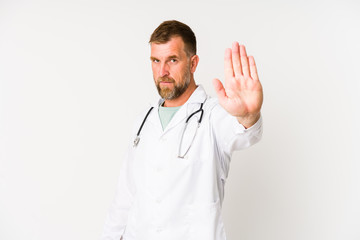 Senior doctor man isolated on white background standing with outstretched hand showing stop sign,...