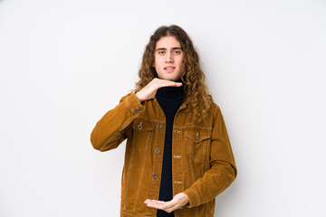 Long hair man posing isolated holding something with both hands, product presentation.