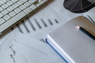 Study table. Charts graphs diagram on table. Financial analytics reviewing documents. Reflection light and flare.