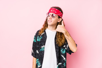 Young hippie caucasian man isolated showing a mobile phone call gesture with fingers.
