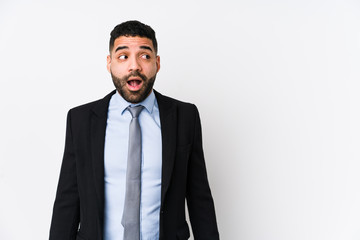 Young latin business woman against a white background isolated being shocked because of something...