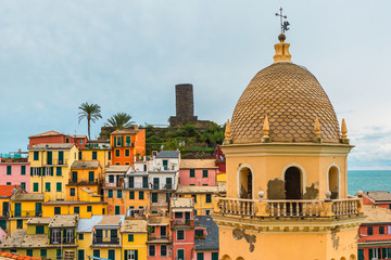 Fototapeta na wymiar Colorful buildings with church in old italian village Vernazza on Cinque Terre coast, Liguria, Italy