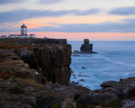 Cape carvoeiro cliff and the lighthouse at sunset om a cloudy say