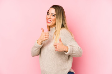 Middle age woman over isolated background raising both thumbs up, smiling and confident.