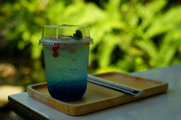 Blue color cold drink on a wood cutting board
