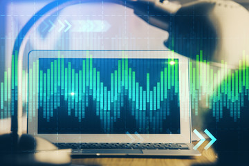 Financial chart drawing and table with computer on background. Multi exposure. Concept of international markets.