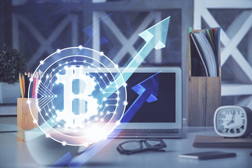 Multi exposure of blockchain and crypto economy theme hologram and table with computer background....