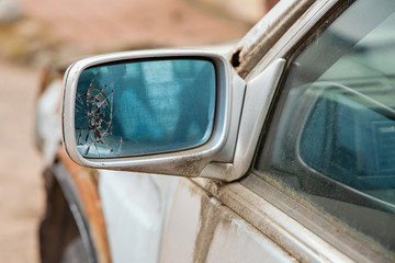 Car with broken side door mirror. Broken car mirror. Cracks in the left rearview mirror