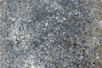 old and worn cement surface in shades of brown, black, grey and white, for background or as a sign of the passage of time in building materials