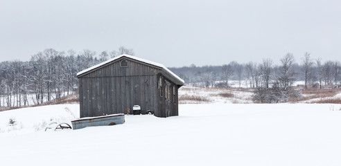 Shed in rural winter landscape
