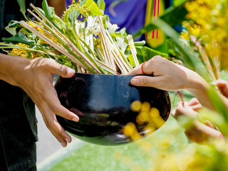Ceremony of offering flowers to monks in Thailand