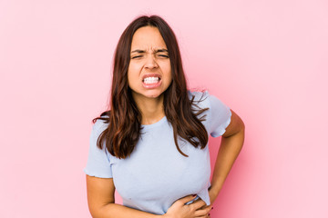 Young mixed race hispanic woman isolated having a liver pain, stomach ache.