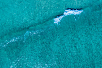 Fototapeta premium Aerial overhad shot waves crashing with motion blur