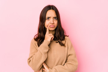 Young mixed race hispanic woman isolated looking sideways with doubtful and skeptical expression.