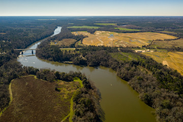 Fototapeta na wymiar Aerial photo winding river with bridge nature landscape