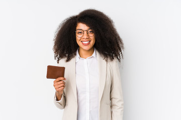 Obraz premium Young afro business woman holding a credit car isolated Young afro business woman holding a credit carhappy, smiling and cheerful.