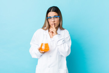 Young scientific woman keeping a secret or asking for silence.