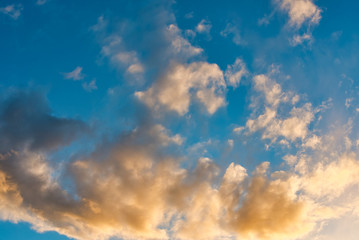 Beautiful sky with clouds at sunset. Soft light from the setting sun. Summer day