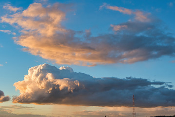 Beautiful sky with clouds at sunset. Soft light from the setting sun. Summer day