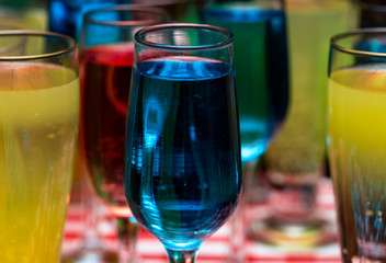 Glasses with a cocktail. Multicolored drinks. Drunk party.