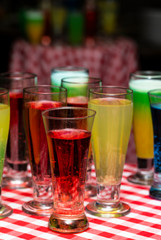 Glasses with a cocktail. Multicolored drinks. Drunk party.