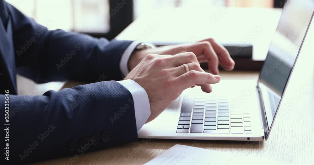 Poster Businessman wears suit typing on computer keyboard. Male hands using laptop business software. Professional executive works online browsing internet on modern tech device at office desk. Close up view