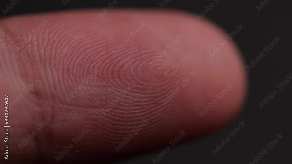 Poster Detail of fingerprint on Caucasian index finger on dark background