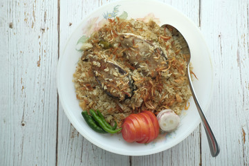 mutton biriyani served in a bowl on white background.