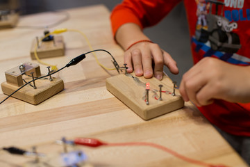 Hands on STEM education activity. Science lesson with hand made electric circuits.