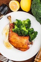 Chicken Legs with Vegetables on wooden table.