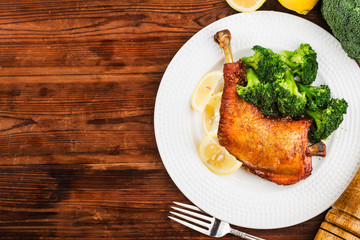 Chicken Legs with Vegetables on wooden table.
