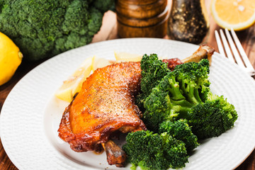 Chicken Legs with Vegetables on wooden table.