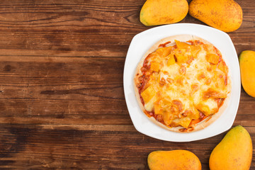 Fresh mango pizza on the table