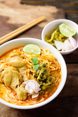 Traditional Northern Thai food (Khao Soi), spicy curry noodles soup with coconut milk and chicken in a bowl