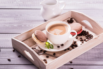 chocolate macaroon with a cup of coffee  on the wooden background