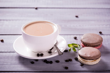 chocolate macaroon with a cup of coffee  on the wooden background