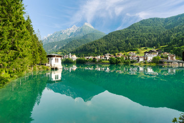 The lake surrounded by green mountains; the village located between valleys