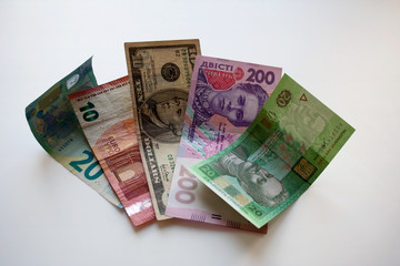 Euro, dollar and Ukrainian hryvnia paper banknotes on white background