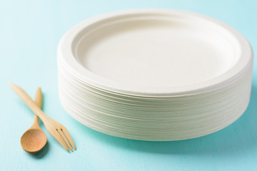 Stack of biodegradable plate, Compostable plate or Eco friendly disposable plate with wooden spoon and fork