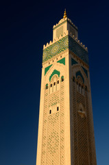 Fototapeta premium Worlds tallest minaret of the Hassan II Mosque in Casablanca Morocco at sunset