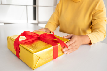 the woman holding a giftbox.