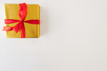 A giftbox on the white table.