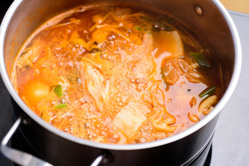 Kimchi soup cooking in hot pot, Korean food