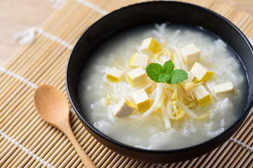 Rice soup with tofu and mung bean sprout in a bowl, Asian food